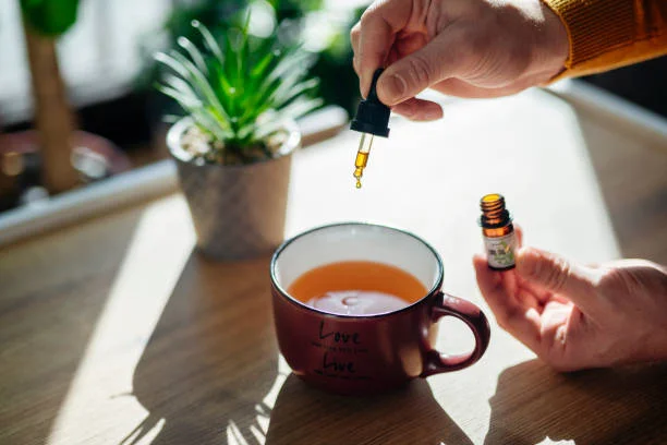 Man at home pours drops of cannabis oil